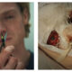 Two-panel image featuring Tom Rhys Harries as Matt Hagen: On the left, a close-up shows him holding up small scissors with a focused expression. On the right, his face is tightly wrapped in medical gauze and netting, with one bloodshot eye and lips exposed around a breathing tube.